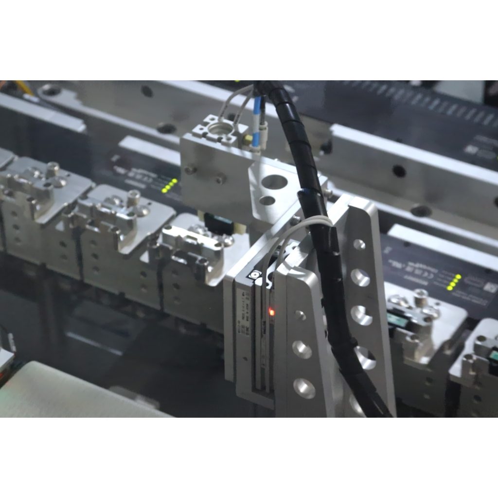 Custom unloading system for finished automotive electronic assemblies