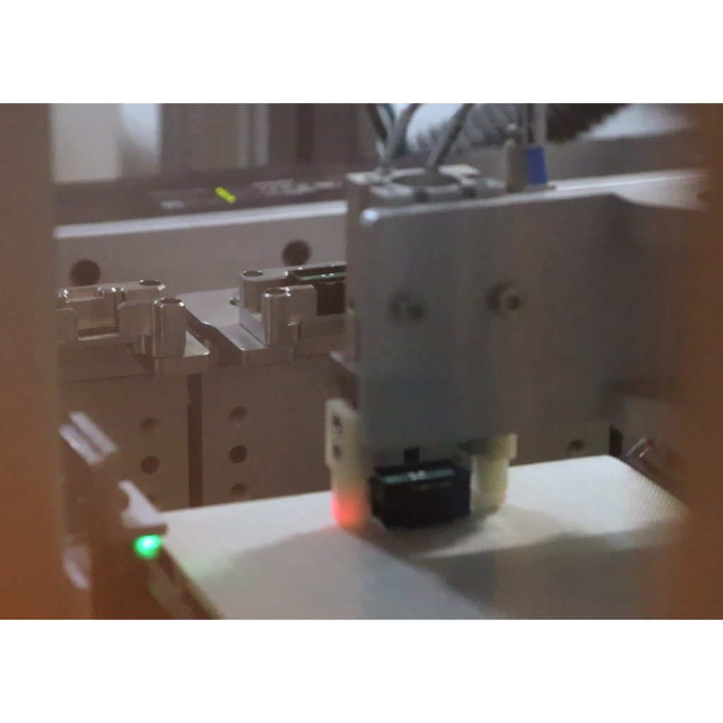 Finished product placed on conveyor at end of custom assembly station