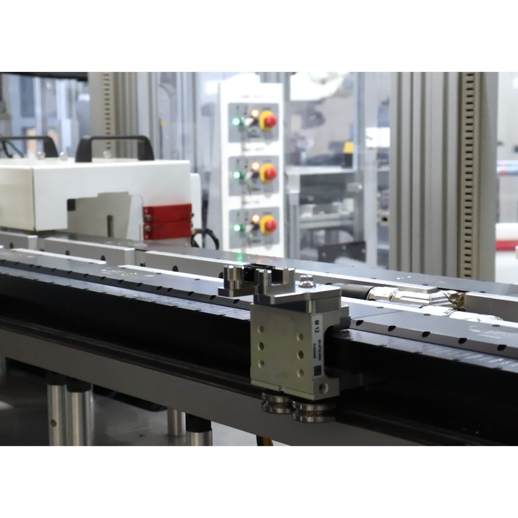 Close-up of custom nest and magnetic conveyor used in electronics assembly