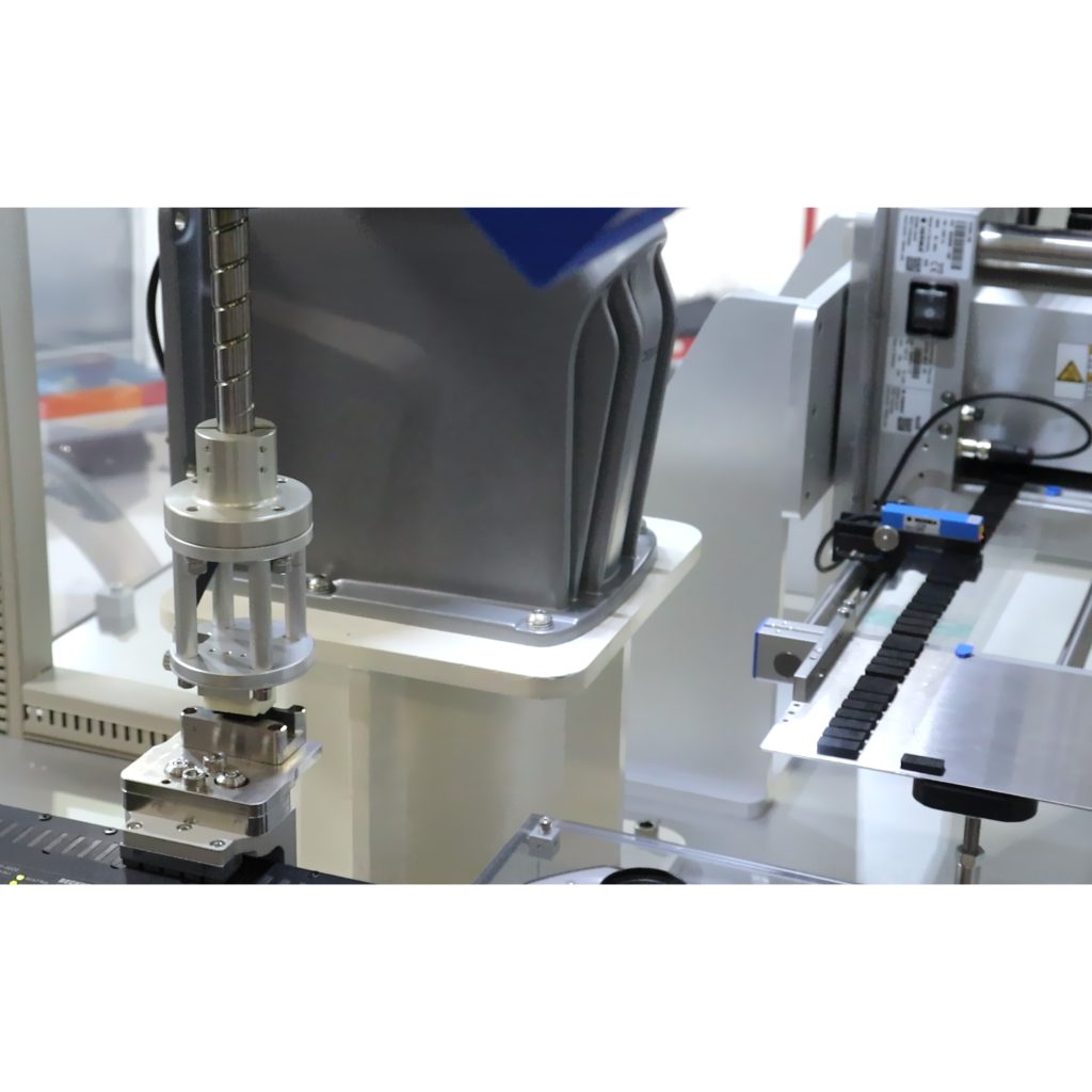 Robot placing mesh on pre-assembled automotive electronic component